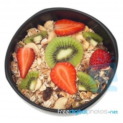 Muesli And Fruits In Bowl Isolated Stock Photo