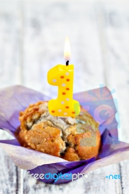 Muffin With Burning Candle Stock Photo