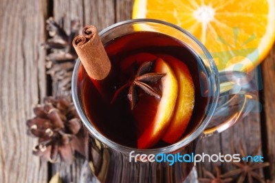 Mulled Wine And Spices On Weathered Wooden Table Stock Photo