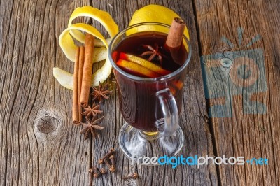 Mulled Wine And Spices On Weathered Wooden Table Stock Photo