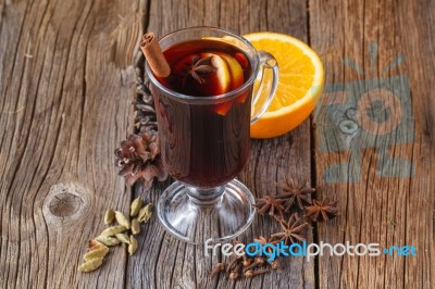 Mulled Wine And Spices On Weathered Wooden Table Stock Photo