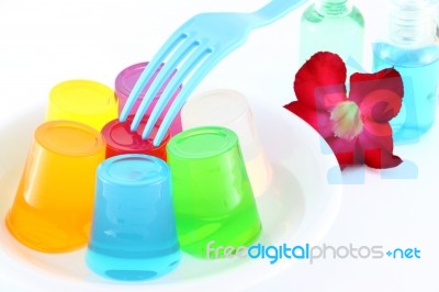 Multiple Cold Jellies On Dish And Blue Fork Stock Photo