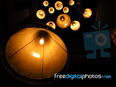 Multiple Warm Lamps With Light Yellow Spots At Night Stock Photo