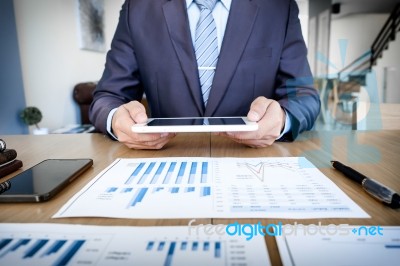 Multitasking. Handsome Young Man Working With Touchpad While Sit… Stock Photo