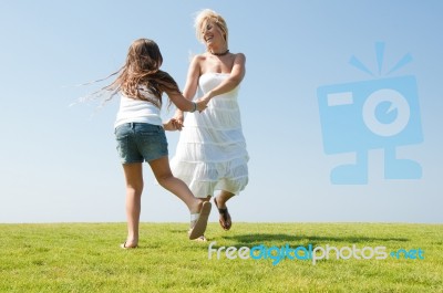 Mum And Daughter Playing in garden Stock Photo