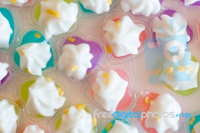 Mung Bean Flour Coconut Dessert In Jelly Close Up In White Foam Dish Floral Background, Leum Kleun Thai Sweets Stock Photo