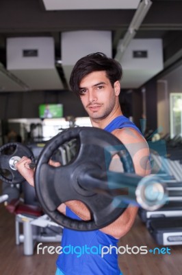 Muscular Bodybuilder Men Doing Exercises With Dumbbells In Gym Stock Photo