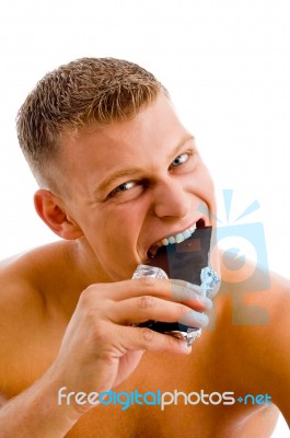 Muscular Man Eating Chocolate Stock Photo