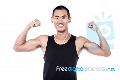 Muscular Man Flexing His Biceps Stock Photo