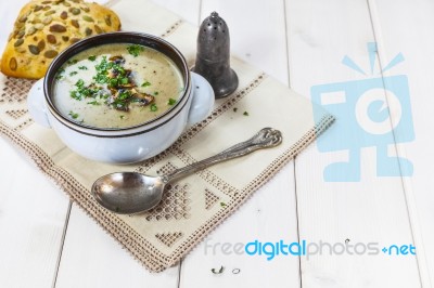 Mushroom Soup With A Bread Roll And Parsley Stock Photo