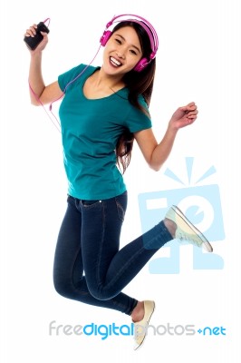 Music Lover Jumping High In The Air Stock Photo