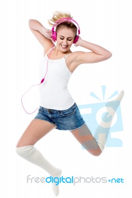 Music Lover Jumping High In The Air Stock Photo