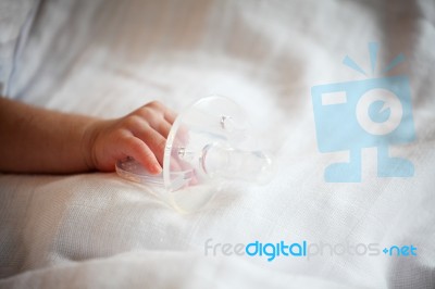 New Born Baby Hand Holding Pacifier Stock Photo