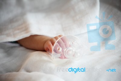 New Born Baby Hand Holding Pacifier Stock Photo