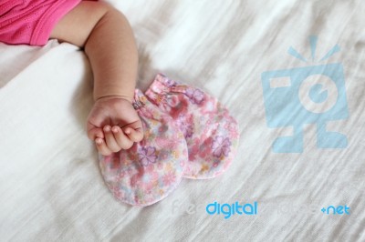 New Born Baby Hand With Pink Color Gloves Stock Photo