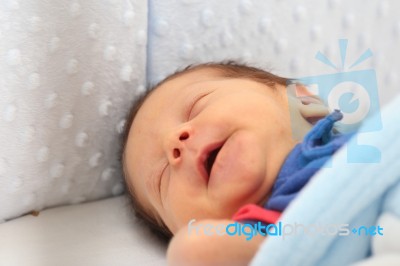 Newborn Smiling In His Dream Stock Photo