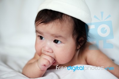 Newborn Sweet Baby With Fingers In Mouth Stock Photo