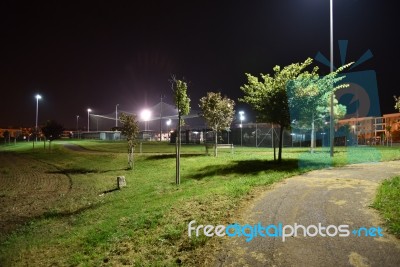 Night Public Park In The City With Houses Near Stock Photo