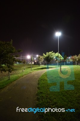 Night Public Park In The City With Houses Near Stock Photo