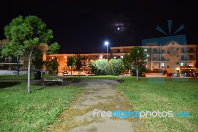 Night Public Park In The City With Houses Near Stock Photo