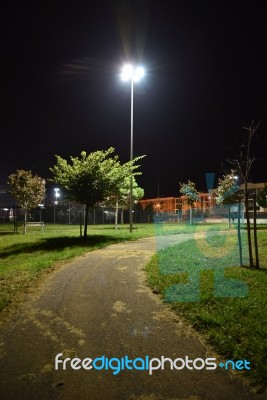 Night Public Park In The City With Houses Near Stock Photo