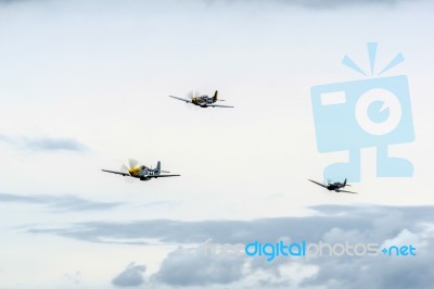 North American P-51d Mustangs And A Spitfire Flying Over Shoreha… Stock Photo