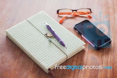 Notebook And Pen On Wooden Table Stock Photo