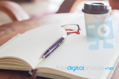 Notebook And Pen With Coffee Cup Stock Photo