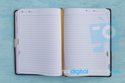 Notebook On Blue Background Stock Photo