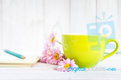 Notebook With A Pencil On The Table Next To Coffee And Flowers Stock Photo