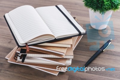 Notebook With Pen On Wood Table Stock Photo