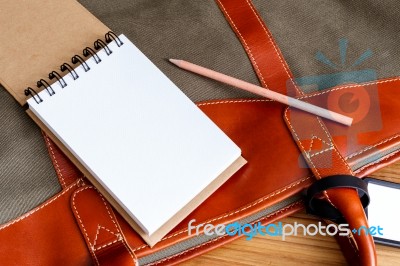 Notebook With Pencil On Travel Bag Stock Photo