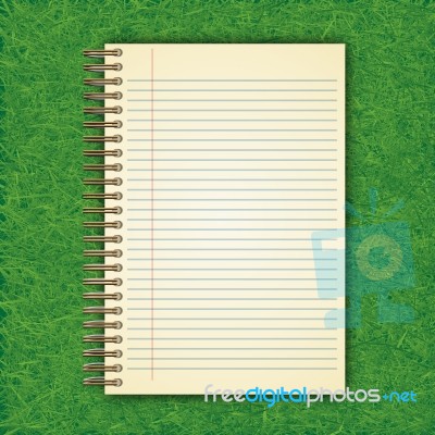 Notebook With White Page On Green Grass Background Stock Image