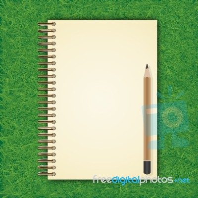 Notebook With White Page On Green Grass Background Stock Image