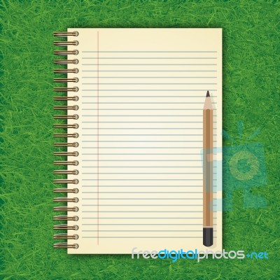 Notebook With White Page On Green Grass Background Stock Image