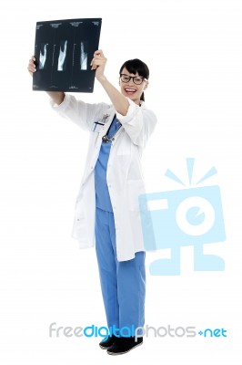 Nurse Holding X-ray Sheet Against Light To Examine Stock Photo