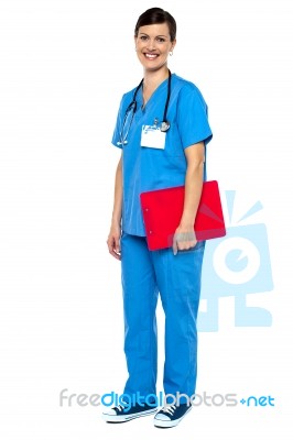 Nurse Wearing Blue Uniform And Holding Red Clipboard Stock Photo