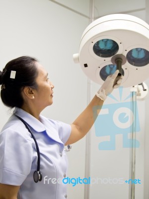 Nurse With Surgical Lamp Stock Photo