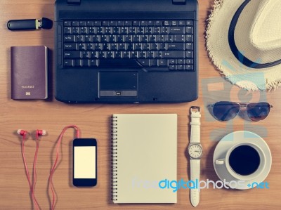 Office Desk With Computer, Supplies, Coffee Cup, Passport, Hat, Stock Photo