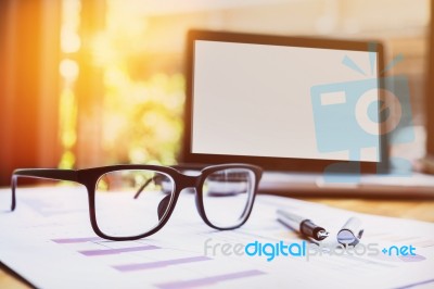 Office Workplace With Laptop And Glasses On Wood Table Stock Photo