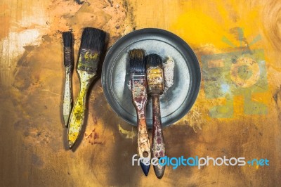 Oil Paint Brushes On Wood Painted Background Stock Photo