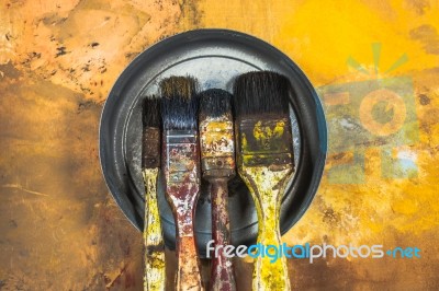 Oil Paint Brushes On Wood Painted Background Stock Photo