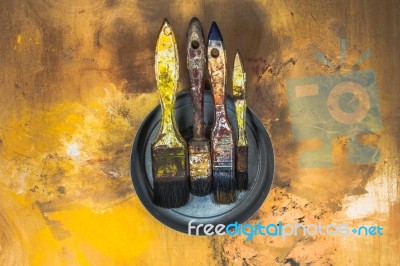 Oil Paint Brushes On Wood Painted Background Stock Photo