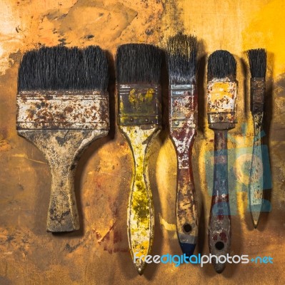 Oil Paint Brushes On Wood Painted Background Stock Photo