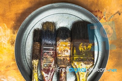 Oil Paint Brushes On Wood Painted Background Stock Photo