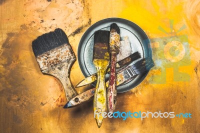 Oil Paint Brushes On Wood Painted Background Stock Photo