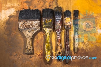 Oil Paint Brushes On Wood Painted Background Stock Photo