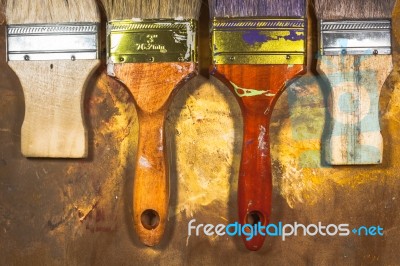 Oil Paint Brushes On Wood Painted Background Stock Photo