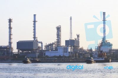 Oil Refinery Plant Beside River In Morning Light Stock Photo