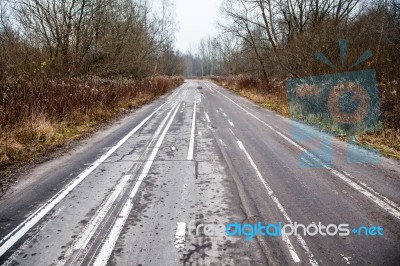 Old Abandoned Asphalt Road With Spoiled Road Markings Stock Photo